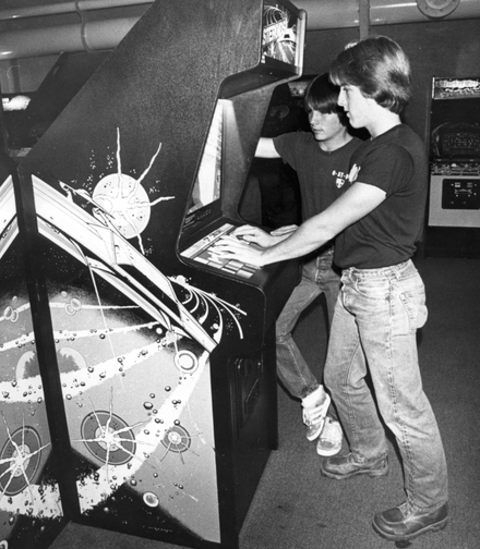 Two boys playing Asteroids in 1981
